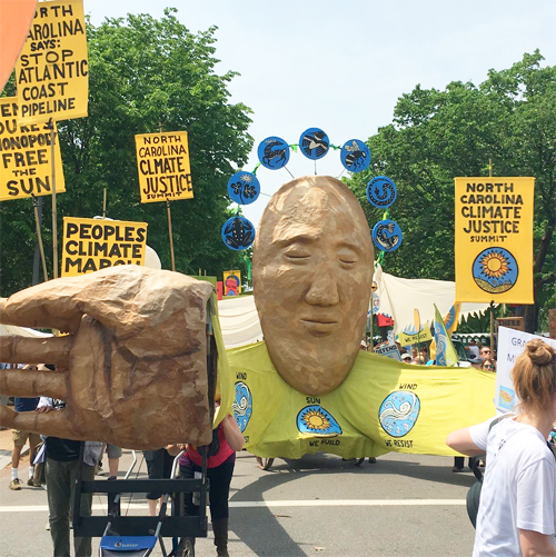 Carolina Climate Justice with banners and face